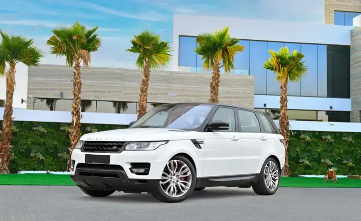 The white Range Rover Sport near to palm tree in Dubai
